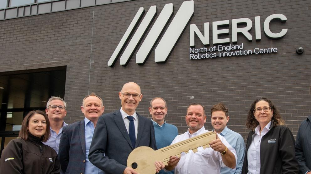 Karl Dayson with staff colleagues outside the North of England Robotics Innovation Centre (NERIC), University of Salford